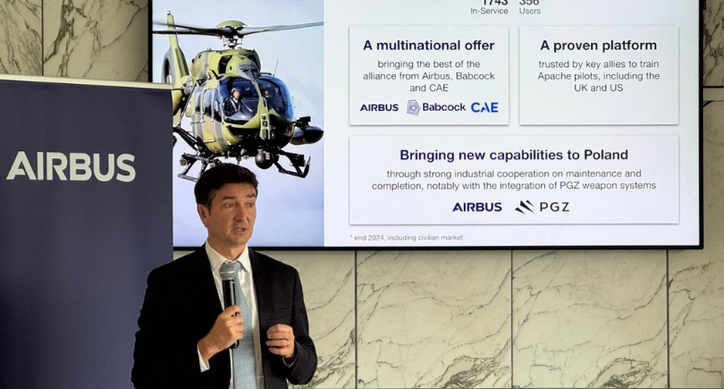 Johan Pelissier, President of Region Europe and Head of Commercial Europe for Commercial Aircraft at Airbus, delivers a presentation in front of a screen displaying the Airbus H145M helicopter programme and its industrial partnerships in Poland.