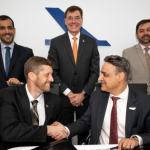 Embraer and Mubadala officials during signing of UAE aerospace partnership agreement.