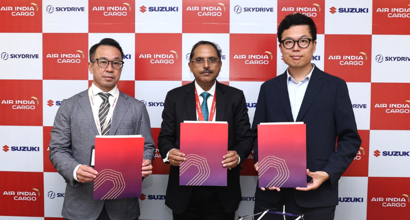 Representatives of Air India, SkyDrive and Suzuki sign an eVTOL logistics MoU.