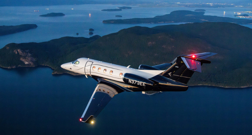 Embraer Phenom 300EV flies over coastal waters during a flight test