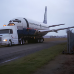 Retired Boeing 737 transported by truck for its final journey.