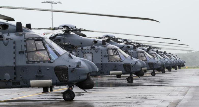 RNZAF NH90 helicopters lined up on a wet airfield