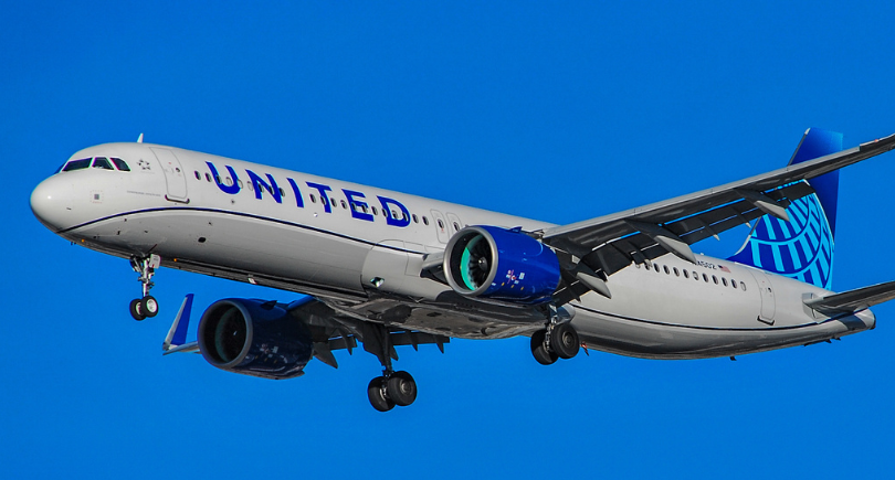 United Airlines aircraft flying against a blue sky