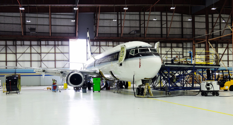 Aircraft undergoes maintenance inside an MRO hangar