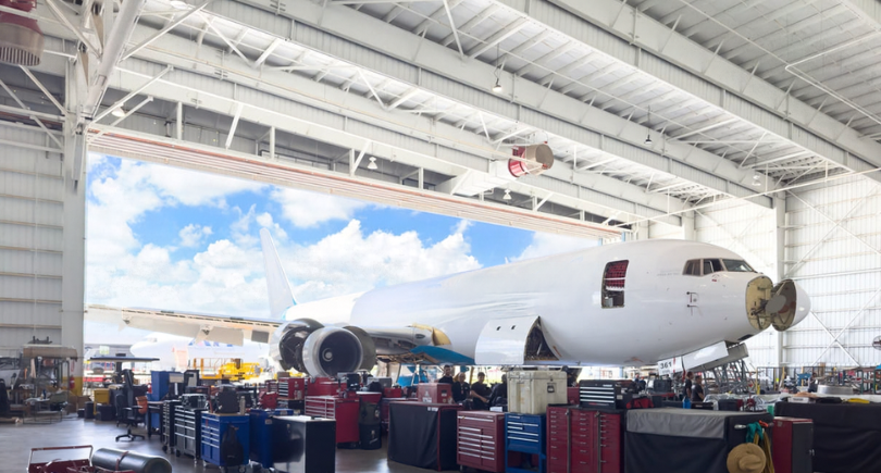 Aircraft undergoing heavy maintenance inside an aviation MRO hangar