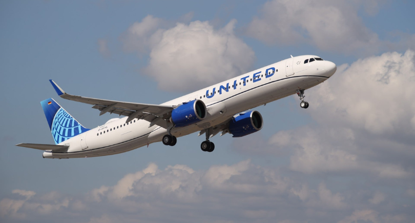 United Airlines aircraft taking off under a cloudy sky
