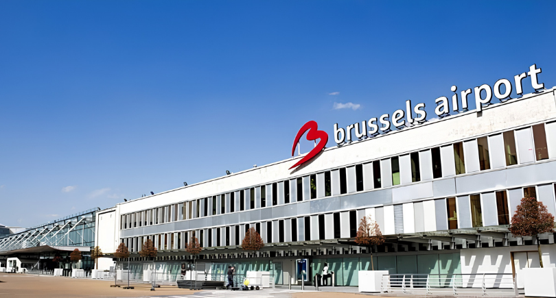 Brussels Airport terminal building under a clear blue sky