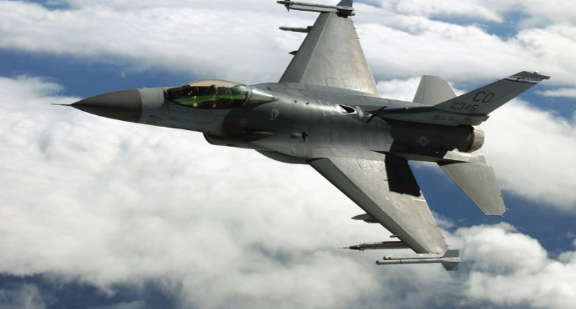 F-16 fighter aircraft flies above clouds during flight