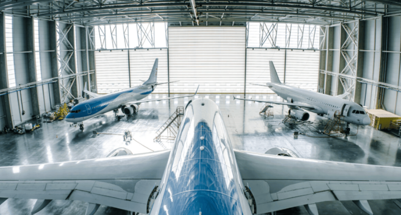 Aircraft undergoing maintenance inside an MRO hangar