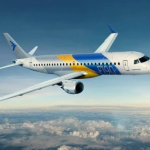 Embraer E190 regional jet flying above clouds following FL Technics' service appointment.